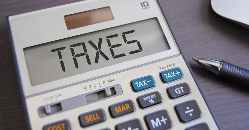 Closeup of a calculator with the word TAXES displayed on the screen